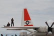 pilots on wing of plane