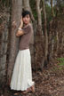 girl at bark fence