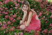 girl in bed of roses